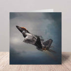 Greeting card of an F22 Raptor fighter jet in flight with a dark, stormy sky background