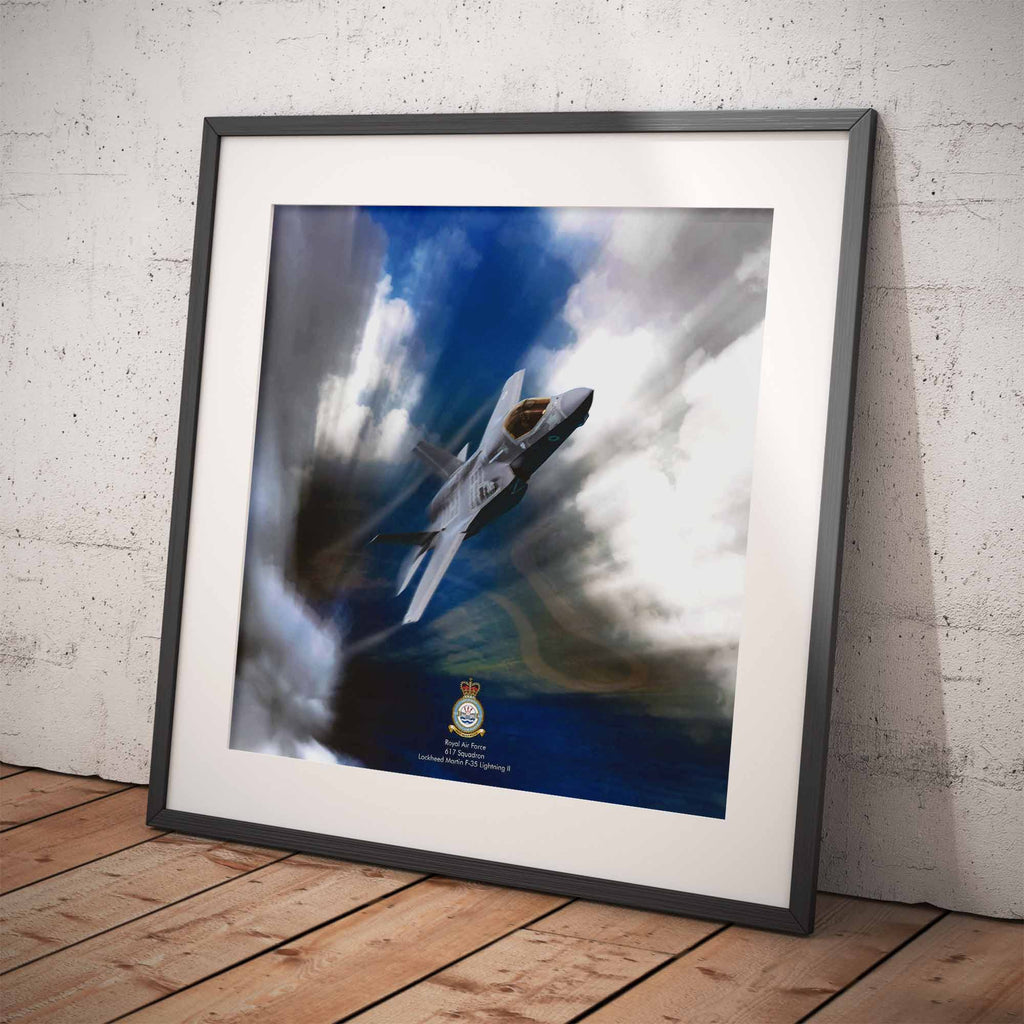 Framed artwork of an F35 Lightning II aircraft against a blue sky with clouds on a wooden floor.