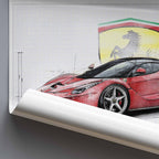 Rolled poster of a red Ferrari LaFerrarisports car with Ferrari logo on a white background