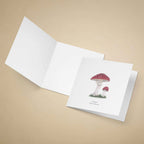 Greeting card watercolour of a fly agaric mushroom on a beige background