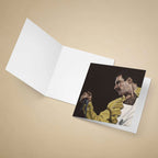 Greeting card with a portrait of Freddie Mercury in a yellow jacket holding a microphone on a beige background