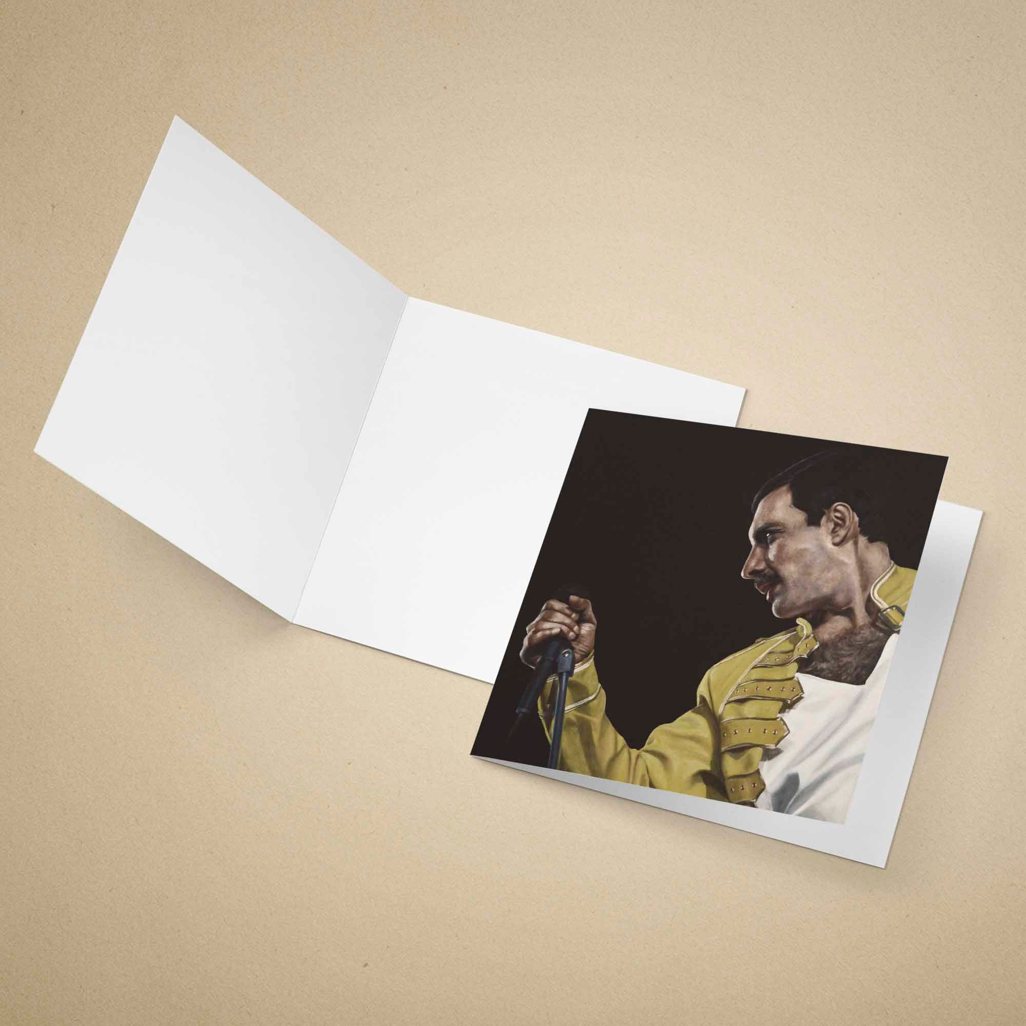 Greeting card with a portrait of Freddie Mercury in a yellow jacket holding a microphone on a beige background