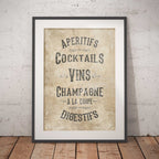 Framed vintage-style poster with a  French drinks menu on a textured wall.