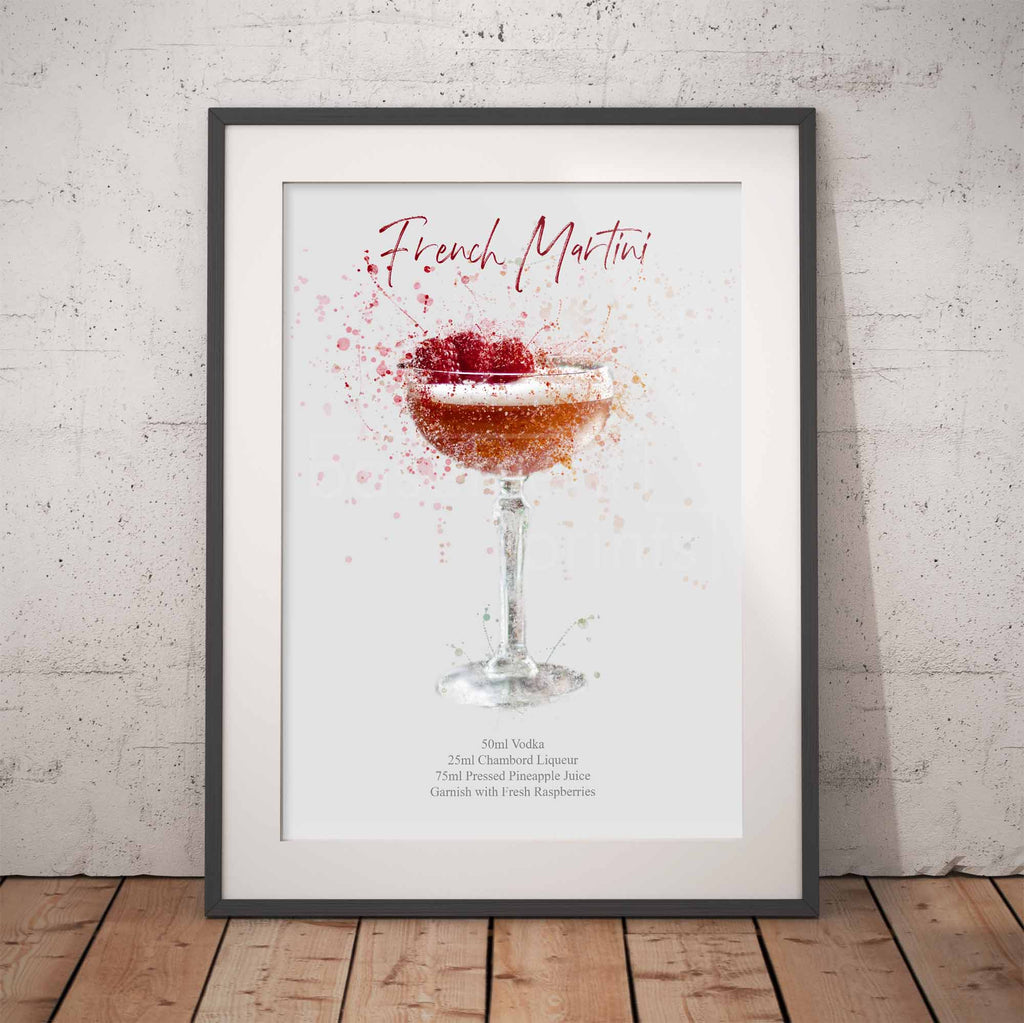 Framed artwork of a French Martini cocktail against a white brick wall.