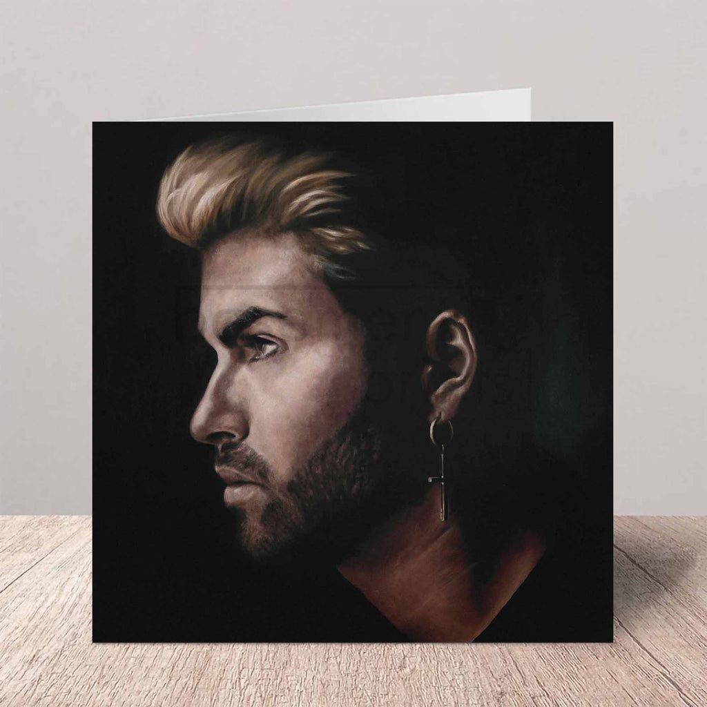 Greeting card with a portrait of George Michael on a wooden floor.
