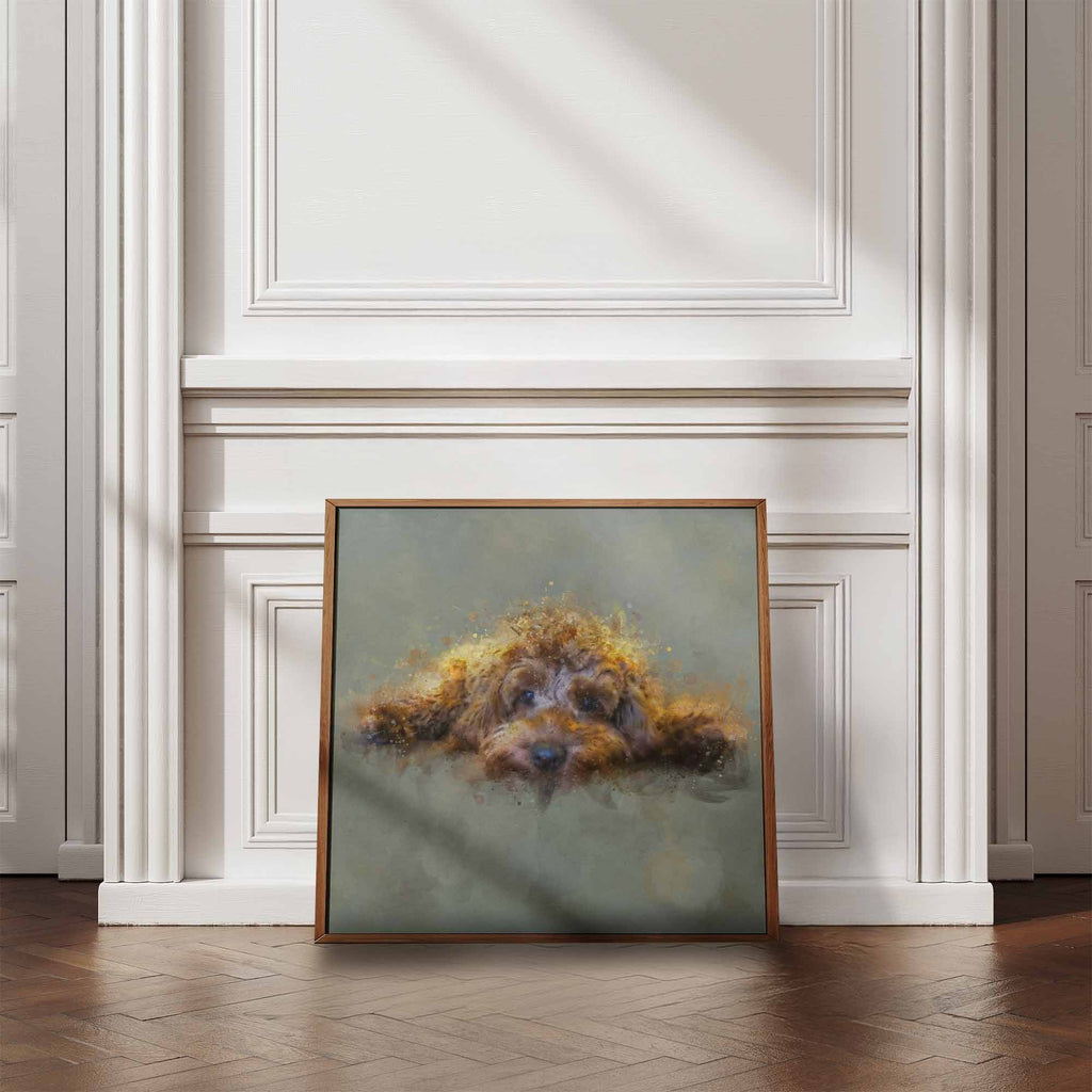 Framed artwork of a golden cockapoo dog on a wall in a room with wooden flooring and white walls.