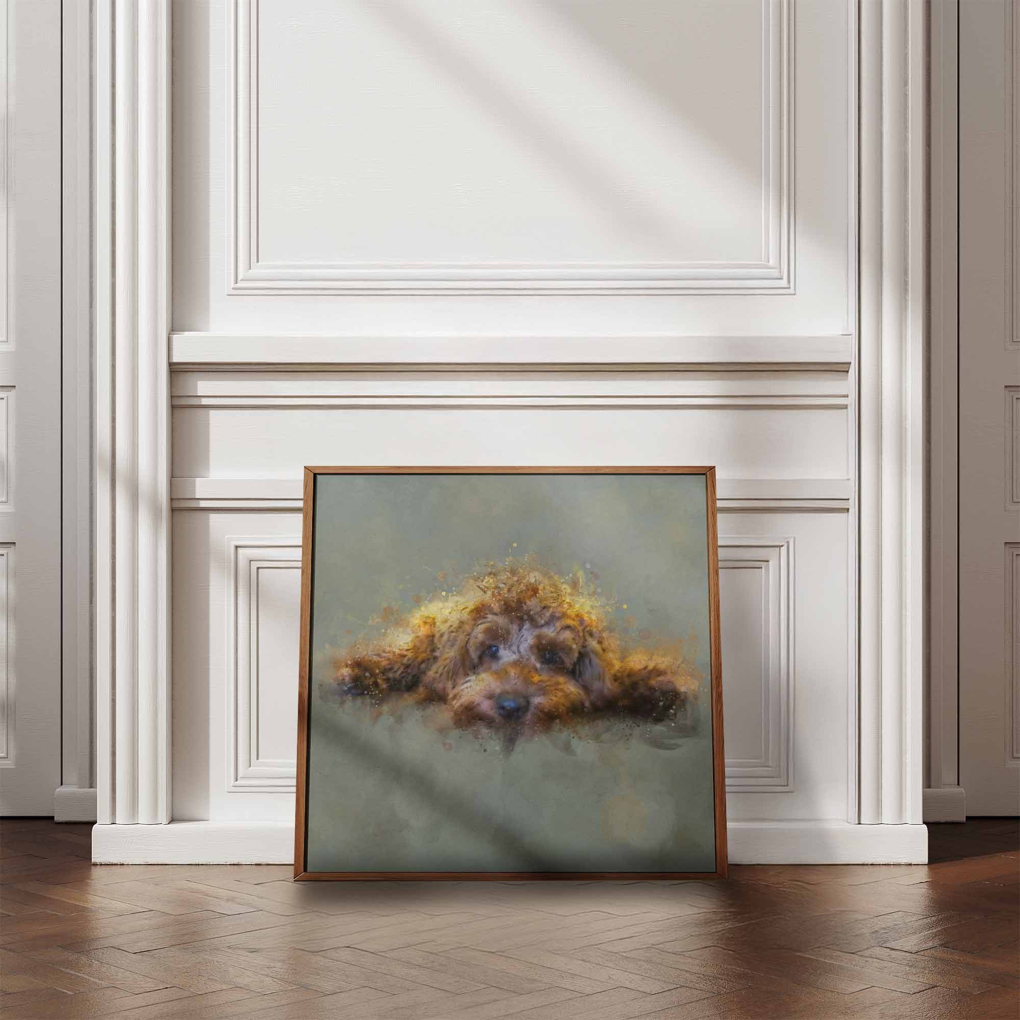 Framed artwork of a golden cockapoo dog on a wall in a room with wooden flooring and white walls.