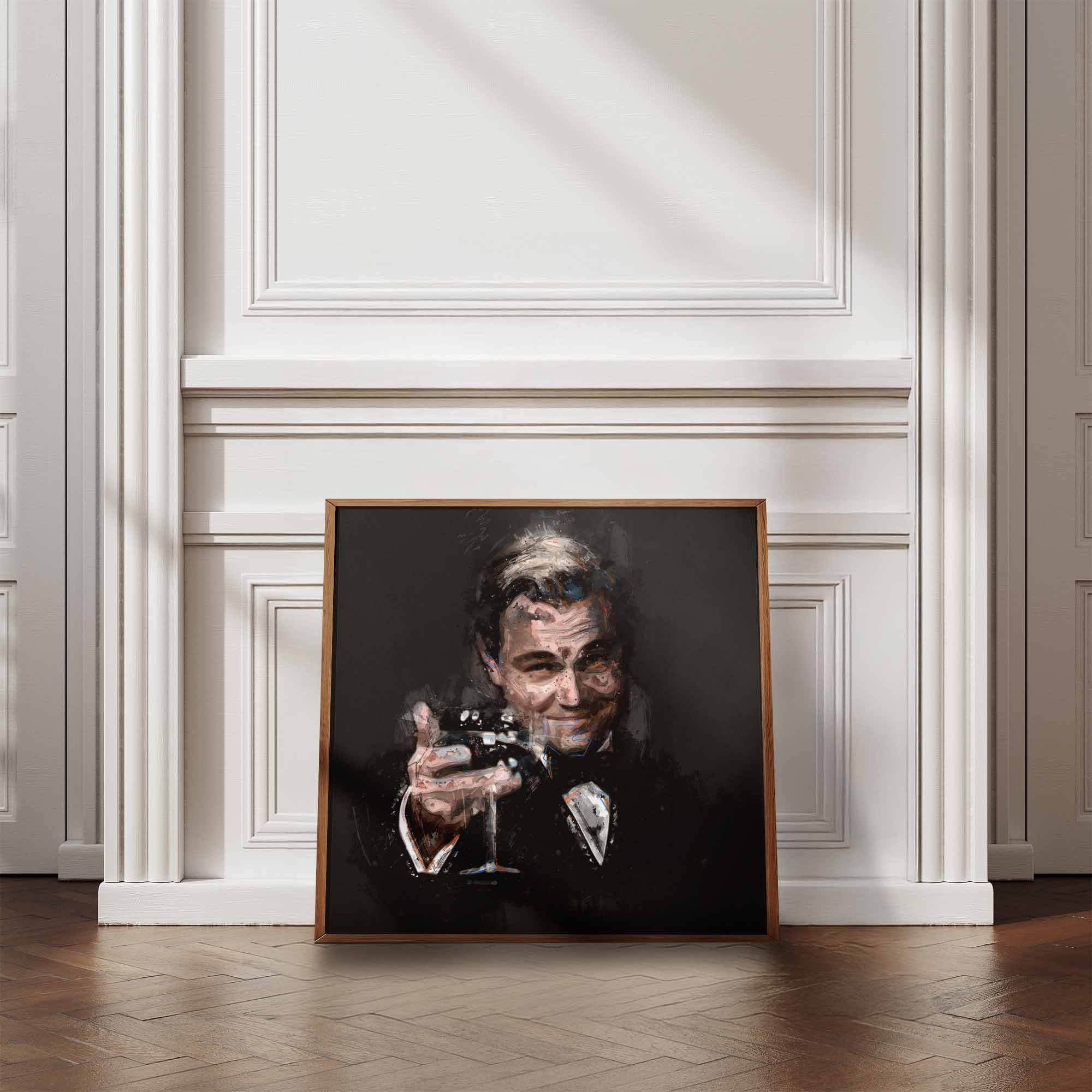 Framed print of a stylised artwork of The Great Gatsby celebratory cheers leaning against a white palled wall and wooden floor.