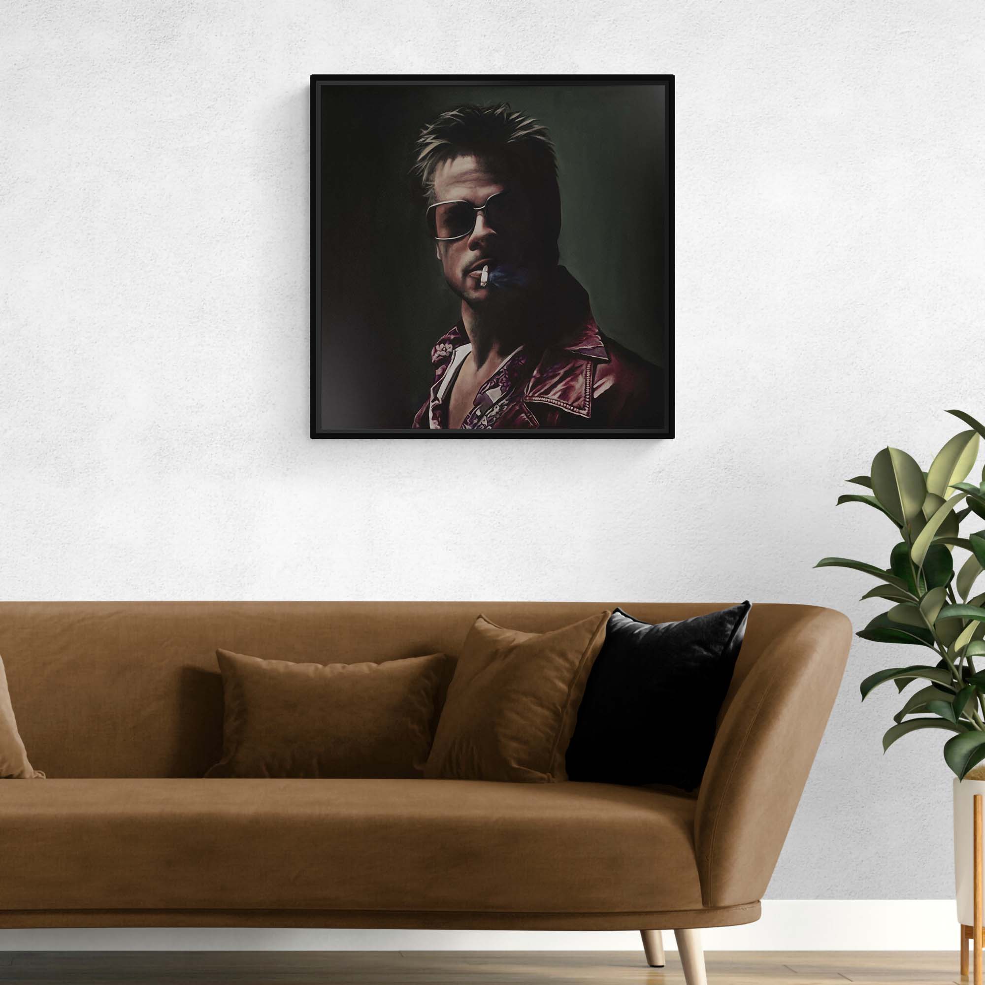 Framed portrait above a brown sofa with decorative pillows in a living room setting.