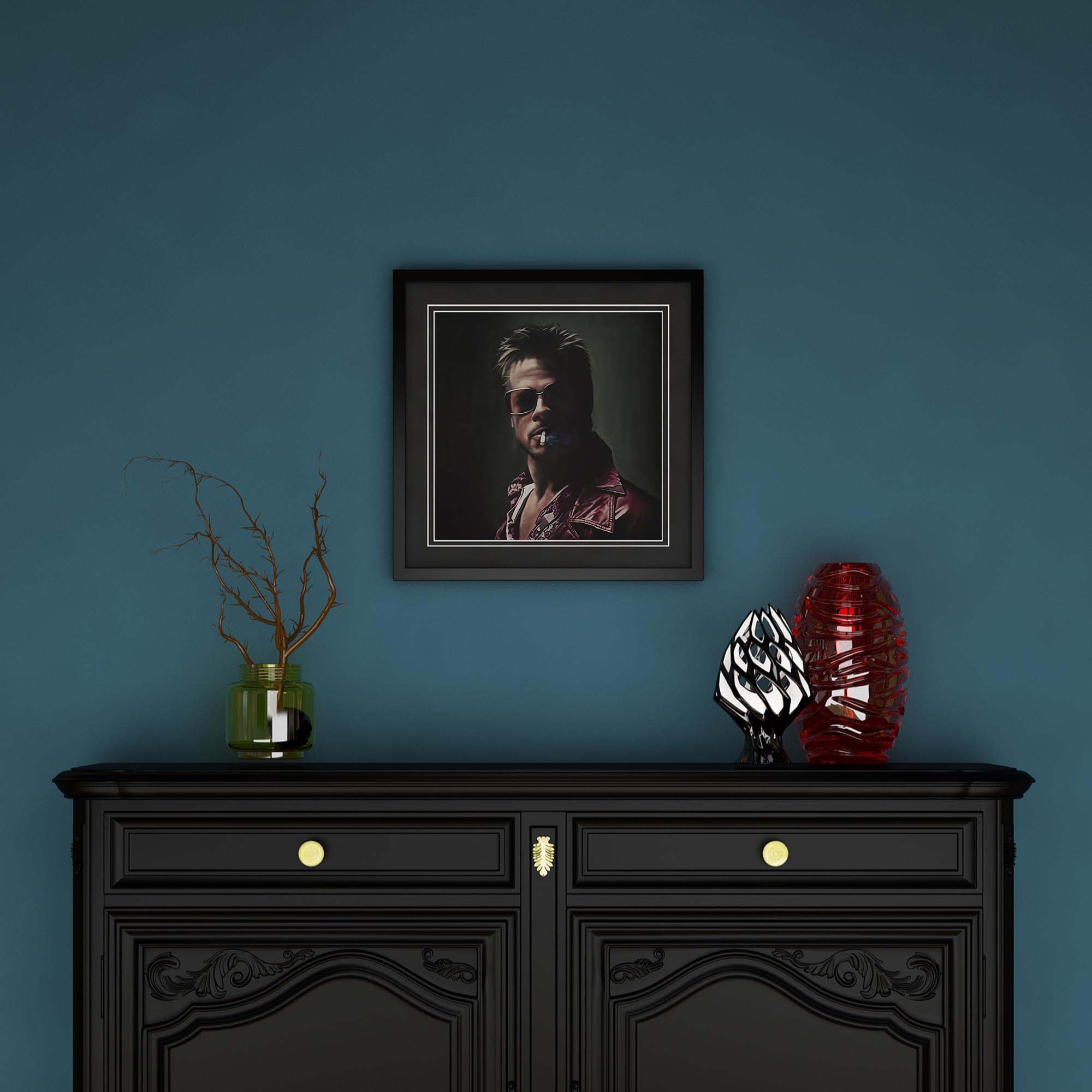 Framed portrait above a black cabinet with decorative items on a blue wall