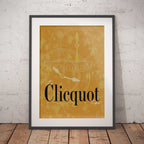 Framed Clicquot poster on a brick wall background