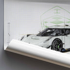 Rolled poster of a Koenigsegg Jesko car design blueprint illustration on a grey background.
