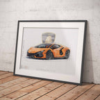 Framed artwork of an orange Lamborghini Revuelto sports car on a wooden floor with a white brick wall background