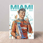 Greeting card of Lando Norris in a racing suit holding an award, with 'MIAMI WINNER 2024' text on a gray background.