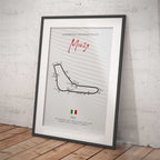 Framed poster of the Monza motor racing track layout on a white brick wall.