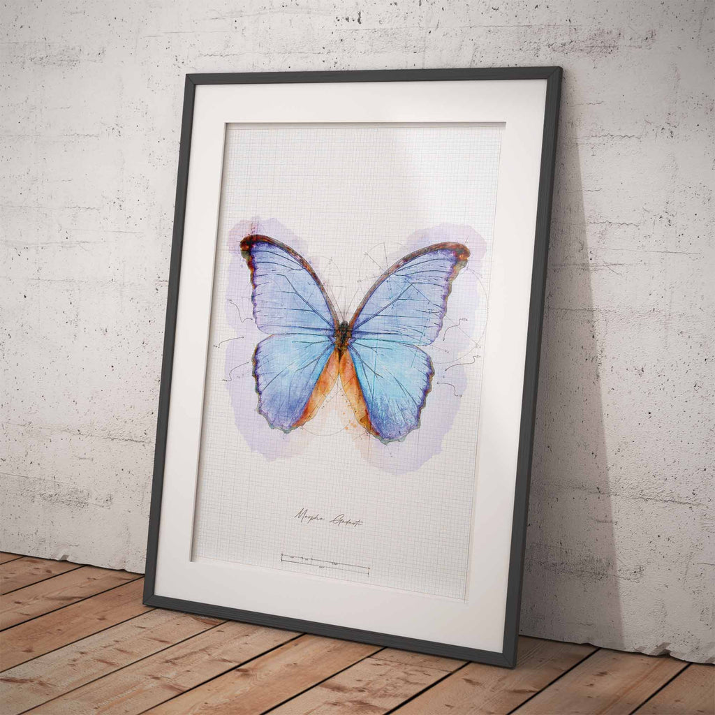 Framed artwork of a blue butterfly on a white background against a brick wall.
