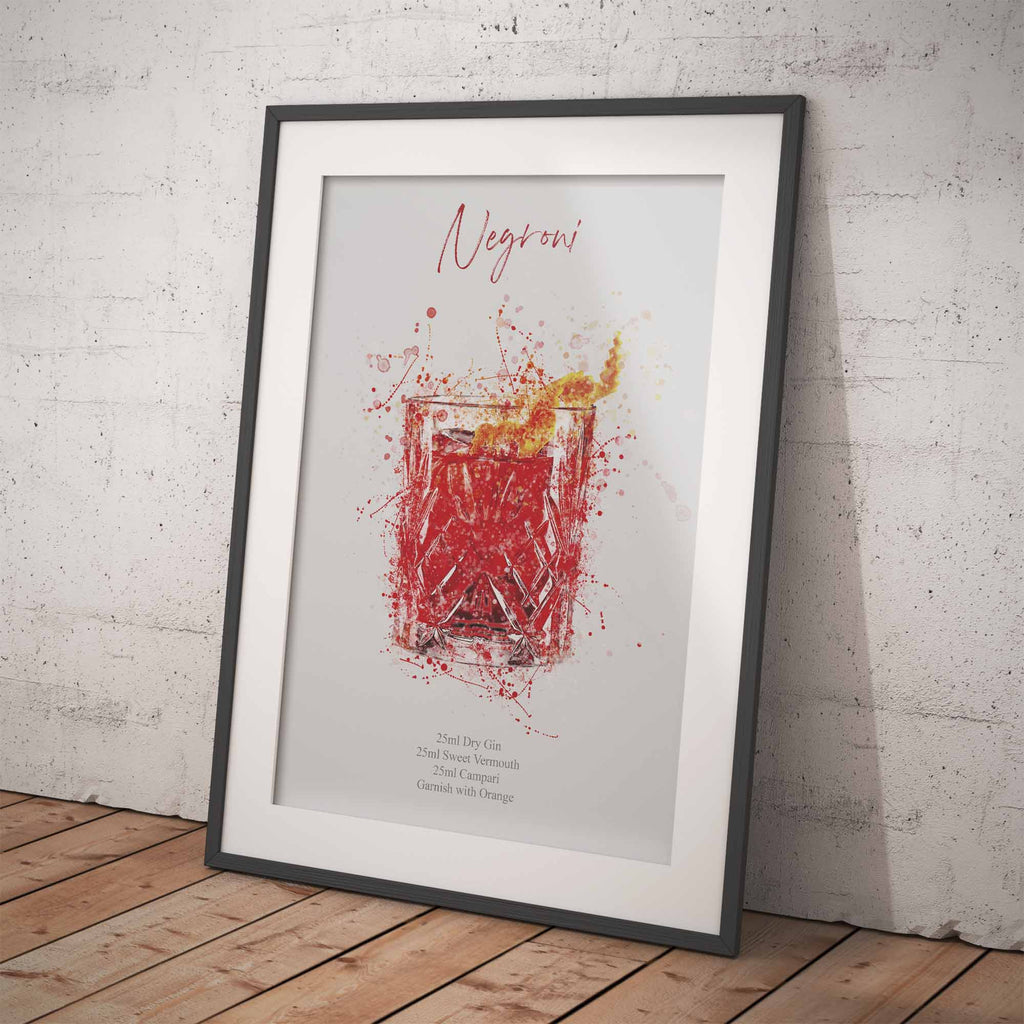 Framed print of a  Negroni cocktail illustration on a brick wall background with a wooden floor.