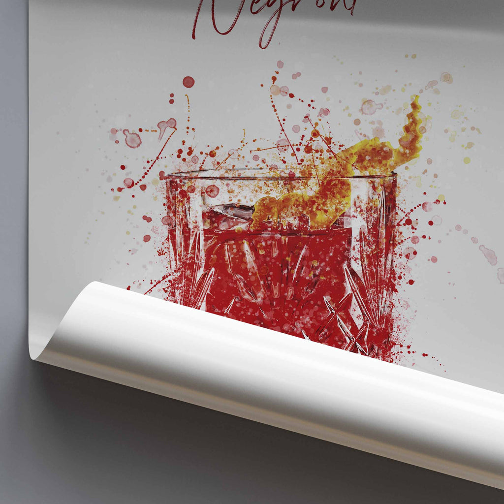 Rolled poster art print of a glass with negroni cocktail and orange splashes on a white background