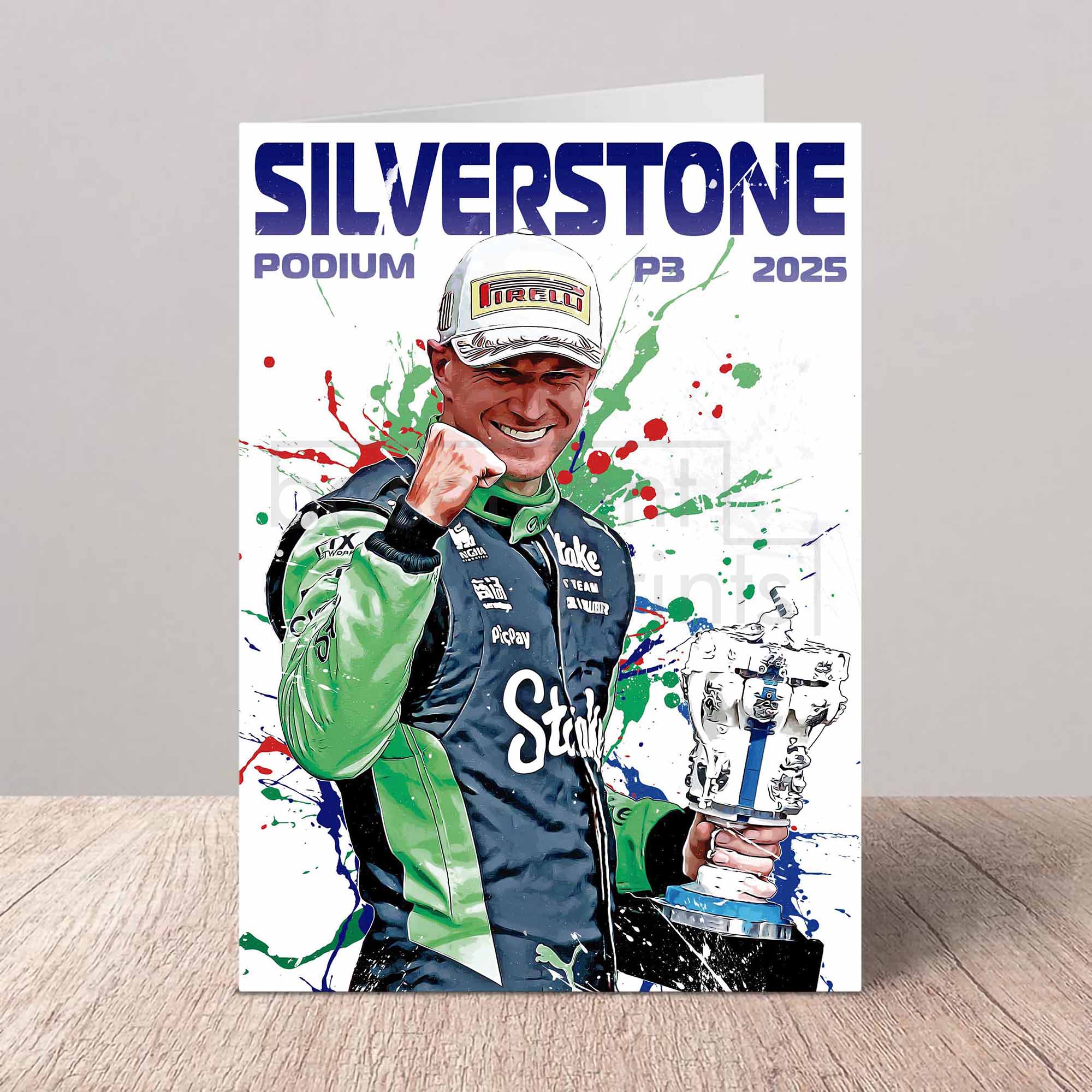 Poster of Nico Hulkenberg r celebrating with a trophy at Silverstone 2025, featuring colorful splashes on a gray background.