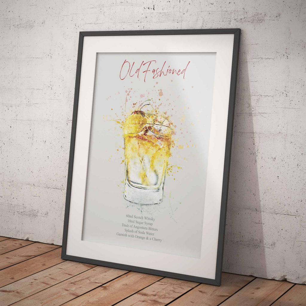 Framed artwork of an old-fashioned cocktail on a wooden floor with a white brick wall background
