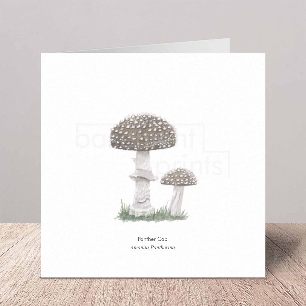 Greeting card with illustration of Panther Cap mushrooms on a wooden surface.