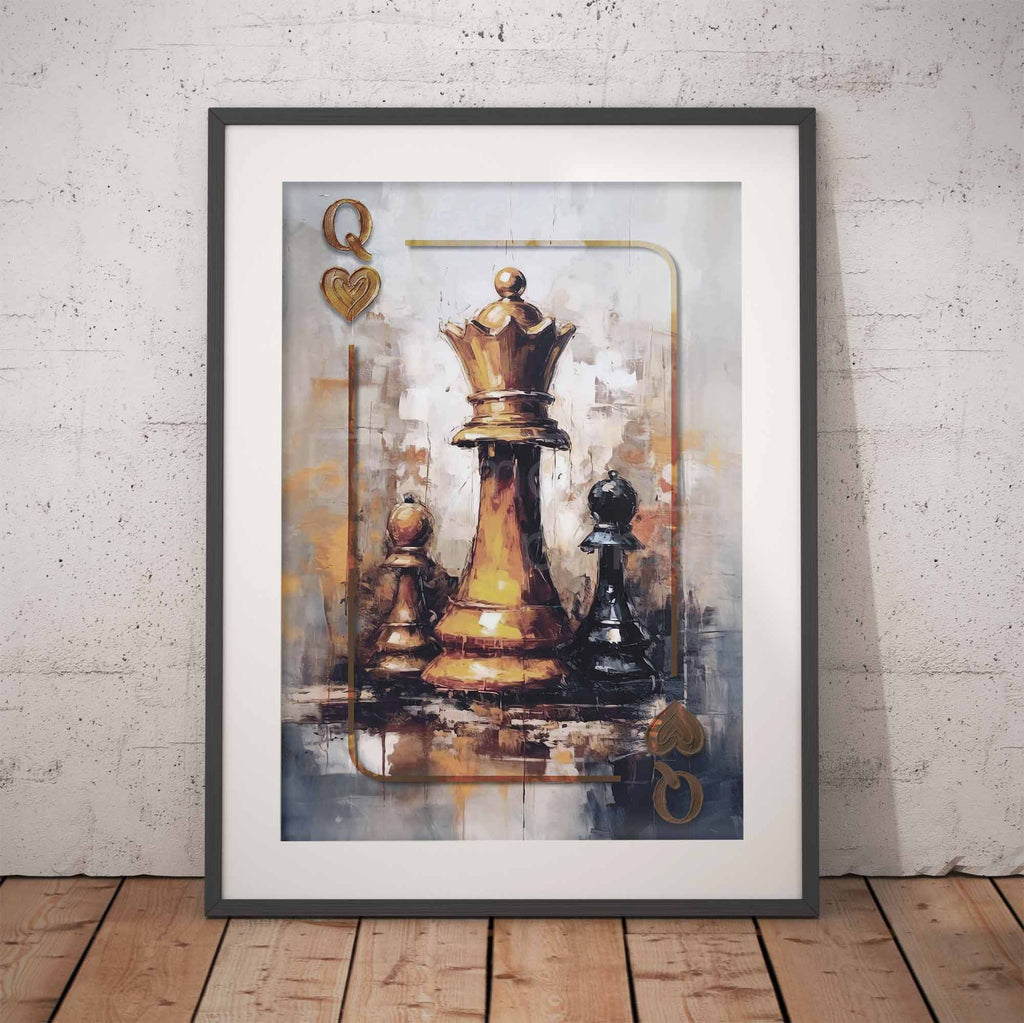 Framed wall art leaning against a light textured wall on a wooden floor, showing an abstract painting of a queen chess pieces inspired by a playing card design with a gold queen and black/white pawns.
