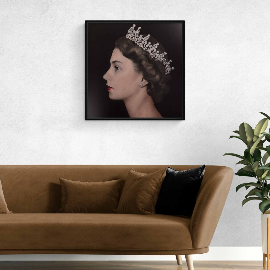 Framed portrait of Queen Elizabeth II with a tiara above a brown sofa with decorative pillows.