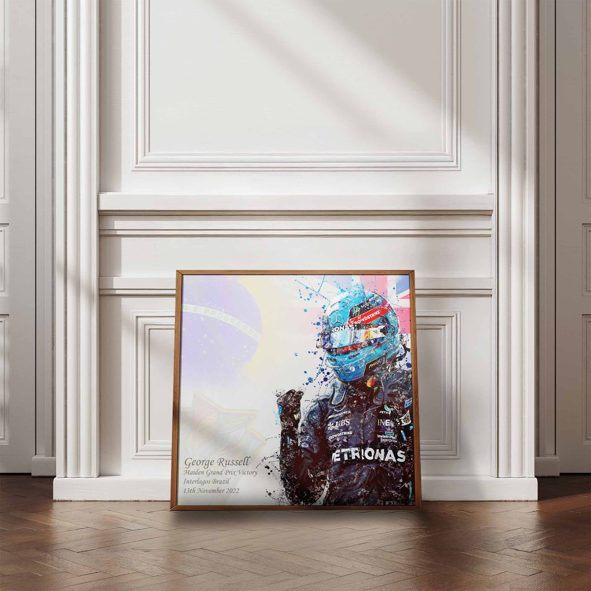 Framed artwork of  George Russell after his first Formula 1 Win on a wall with wooden flooring.