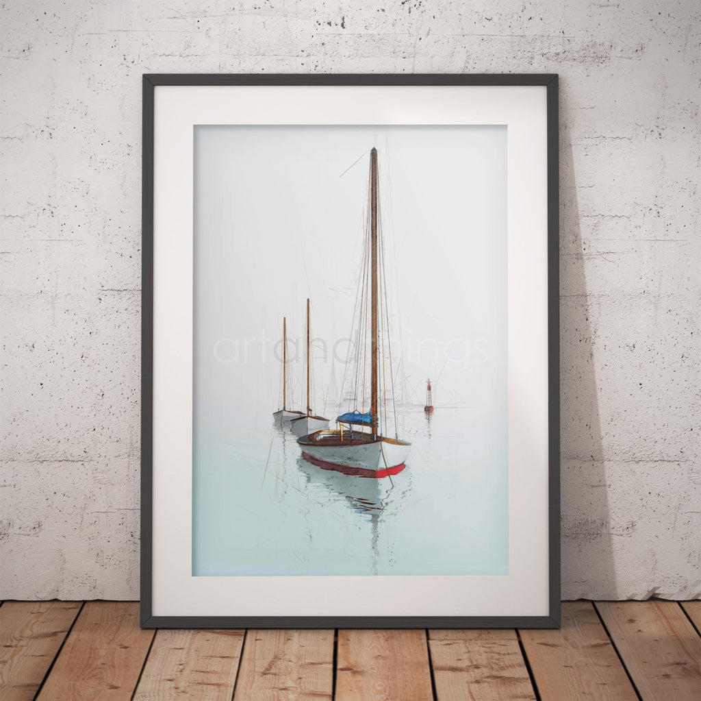 A framed art print depicting three sailboats on a calm, misty light blue water surface, leaning against a white textured brick wall on a wooden floor.
