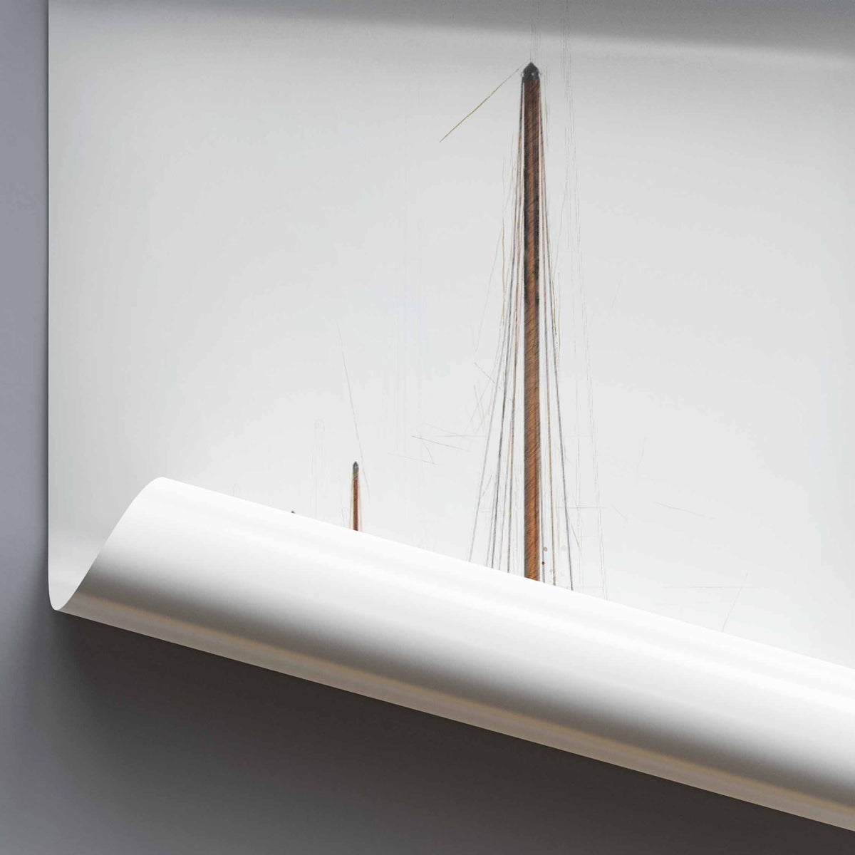 A close-up of a white rolled poster against a light gray background, with a small wooden sailing boat mast.