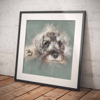 Framed artwork of a Schnauzer dog, leaning against a textured white wall.