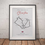 Framed poster of Silverstone circuit layout on a white brick wall background