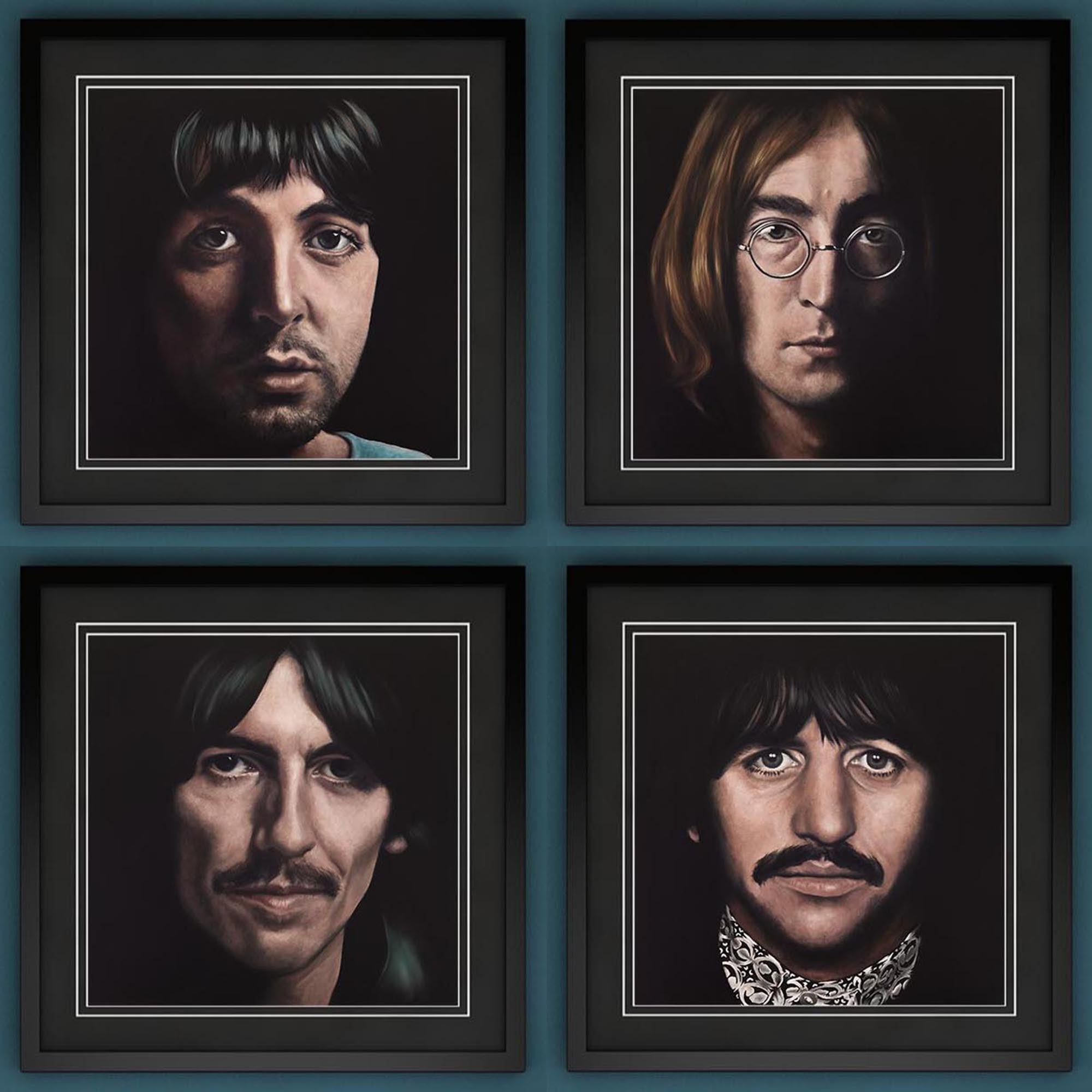 Four framed portraits of each member of The Beatles on a blue background
