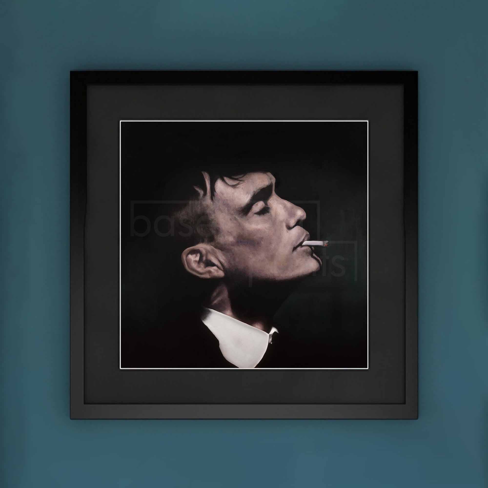 Framed artwork of Thomas Shelby smoking a cigarette on a blue wall.
