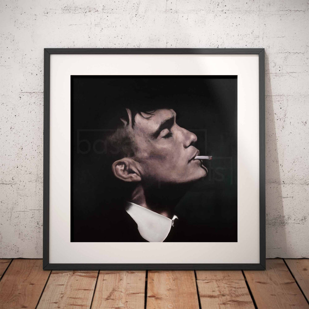 Framed portrait of Thomas Shelby smoking a cigarette against a brick wall.