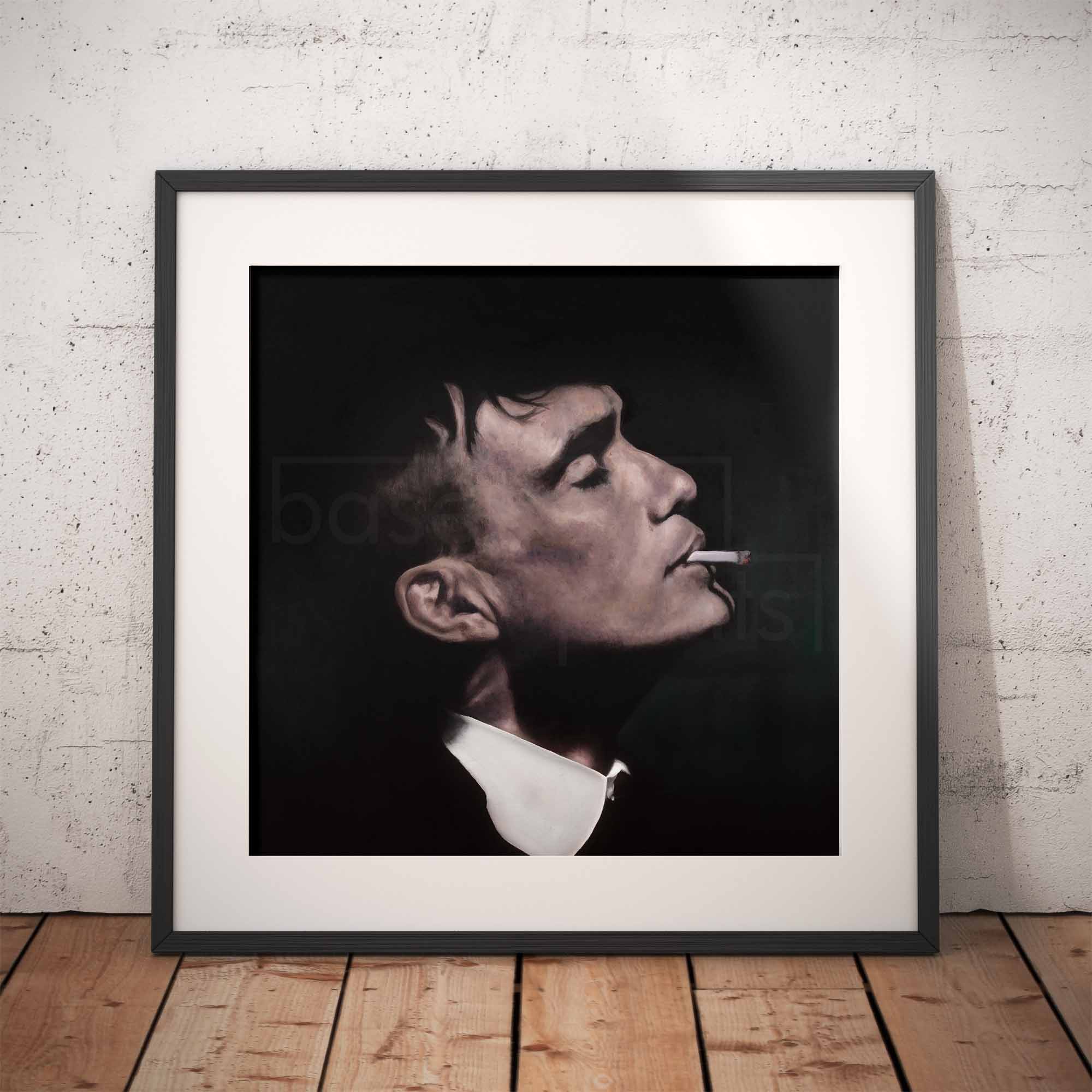 Framed portrait of Thomas Shelby smoking a cigarette against a brick wall.