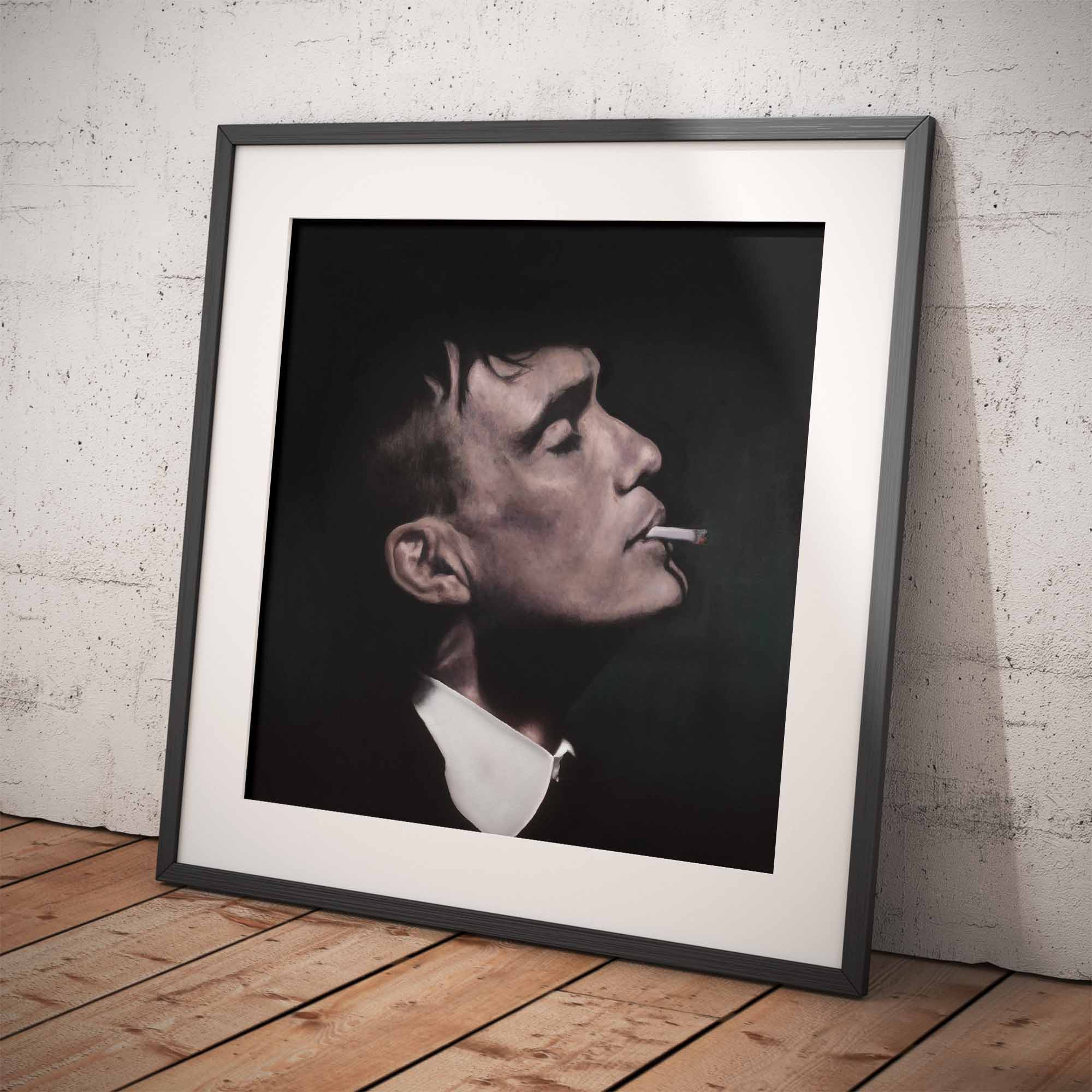 Framed portrait of Thomas Shelby smoking a cigarette on a wooden floor with a white brick wall background.