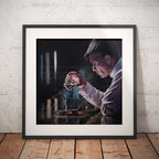 Framed artwork of Thomas Shelby from Peaky Blinders holding a whisky glass on a wooden floor with a white brick wall background.