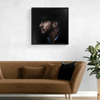 Framed portrait of Tom Hardy above a brown sofa with decorative pillows in a living room setting.