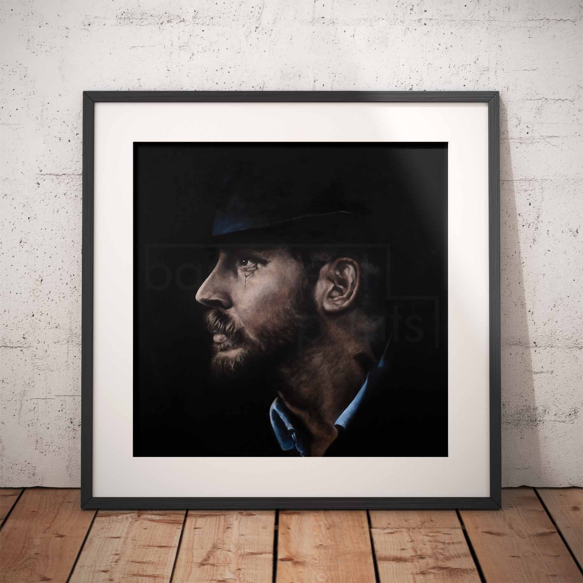 Framed portrait of a man with a beard and hat on a brick wall background