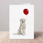 Greeting card with a yellow Labrador holding a red balloon on a white background