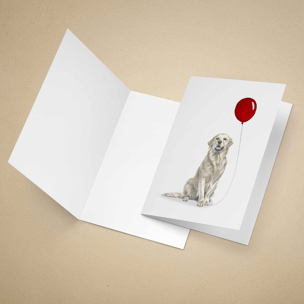 Greeting card with a yellow Labrador holding a red balloon on a beige background